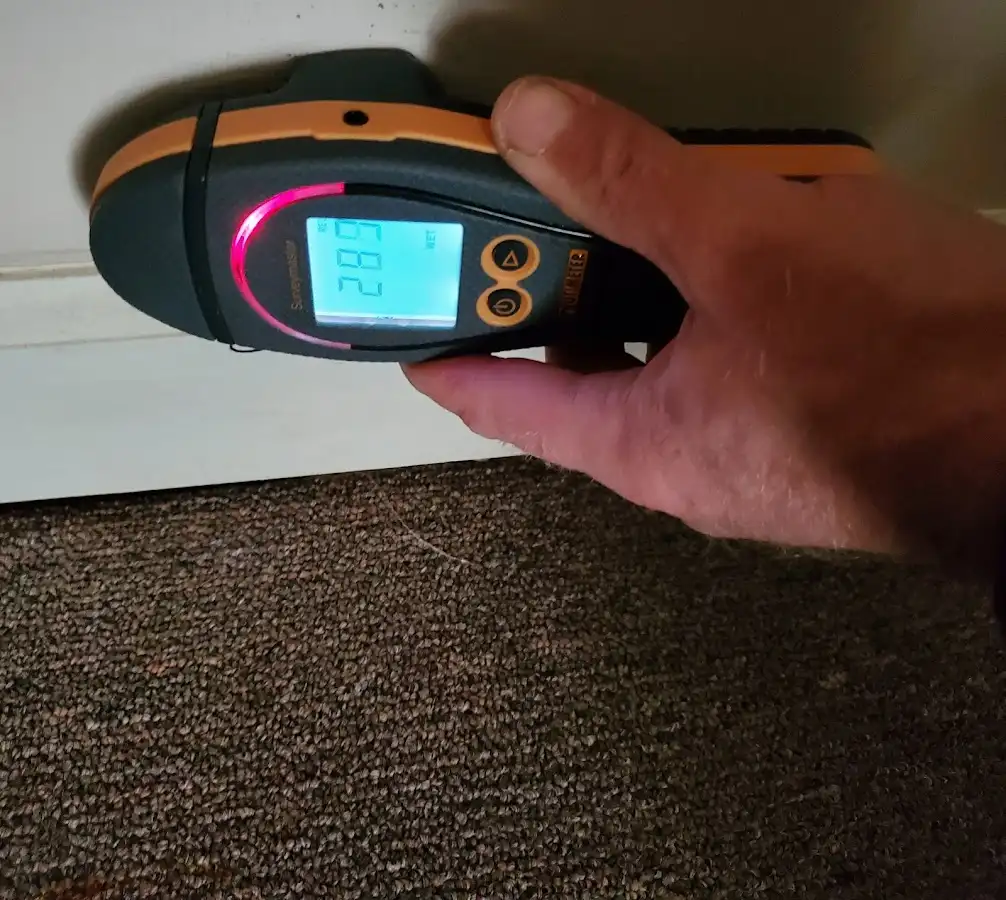 Moisture detection at baseboard during Storm Damage Restoration in Spirit Lake